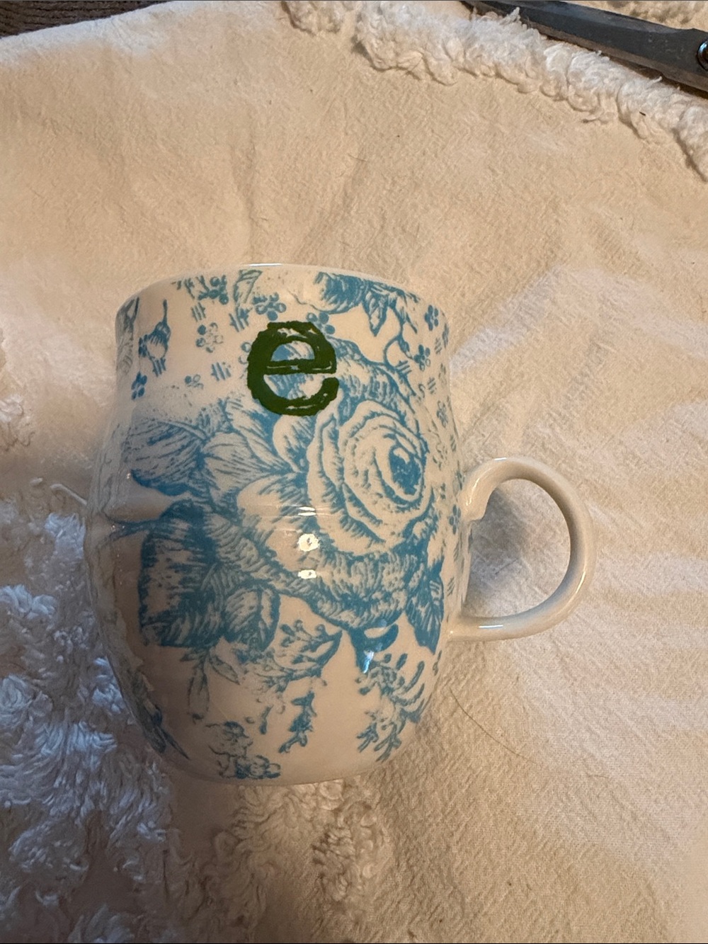 Anthropologie White Ceramic Mug with Blue Floral Pattern and Green E